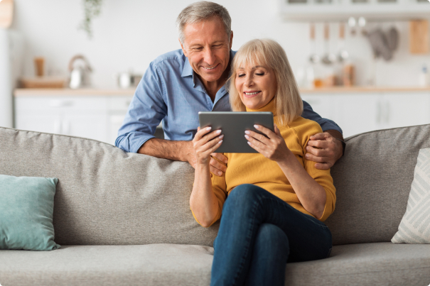 photo of couple looking at tablet together